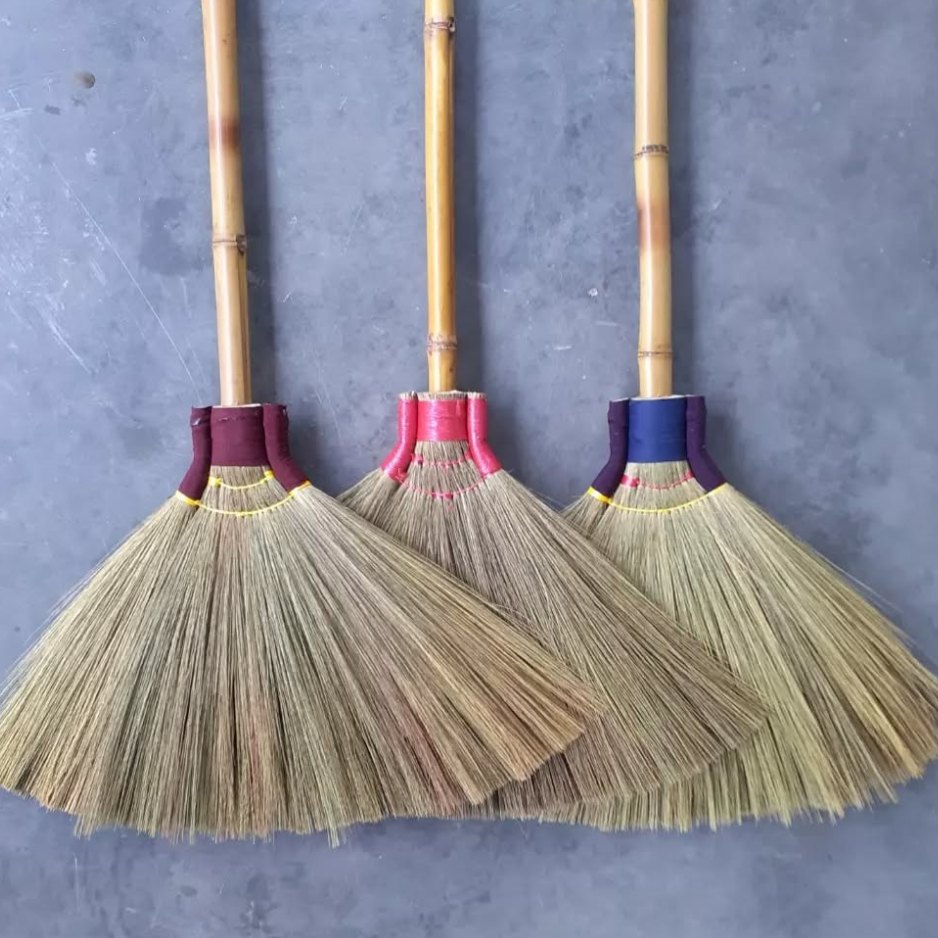 Grass broom builders crafting natural grass brooms by hand