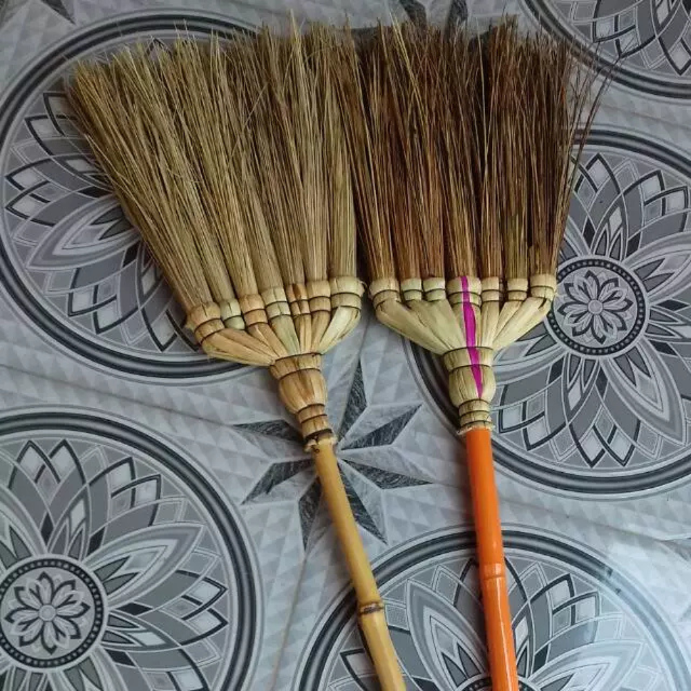 Coconut leaves broom crafted from dried coconut leaves for household use